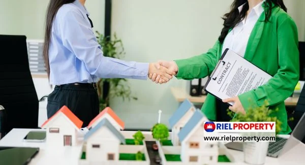 Foreign investor reviewing a Cambodia strata title showing bilingual Khmer and Latin script ownership details